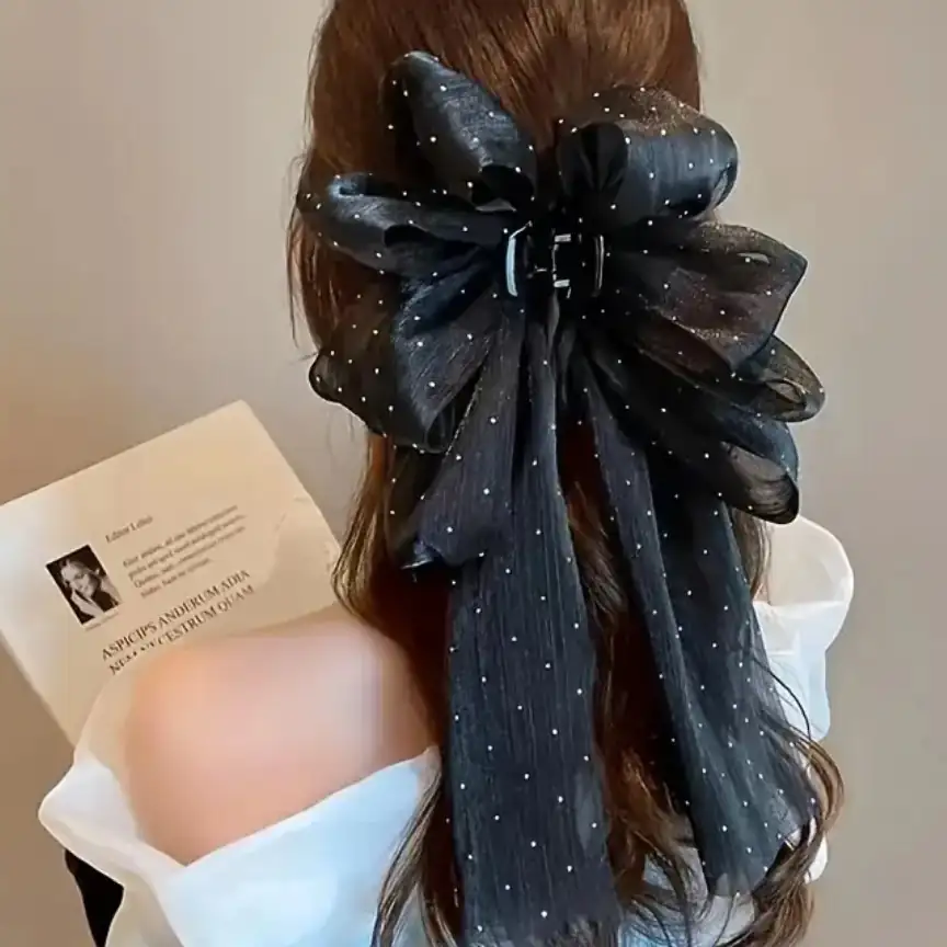 Pinza con moño negro