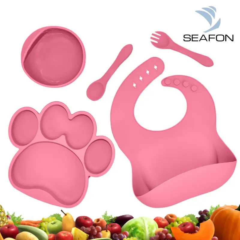 Combo de babero, tazón, cucharas y silicona para bebes. Cinco piezas en color rosa. 