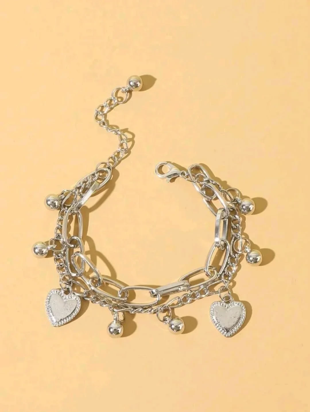 Pulsera con dijes ajustable en acero inoxidable color plata  2