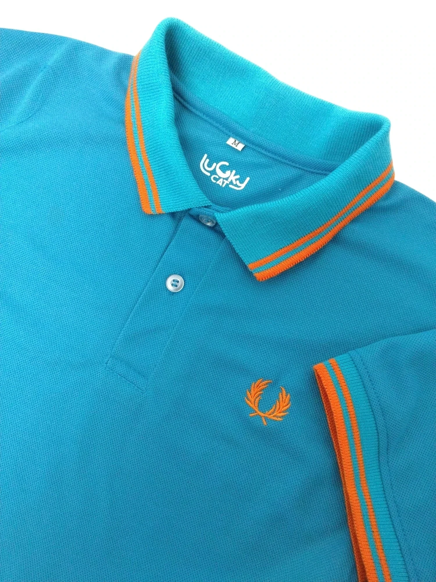 Camisa polo aqua con narnaja 
