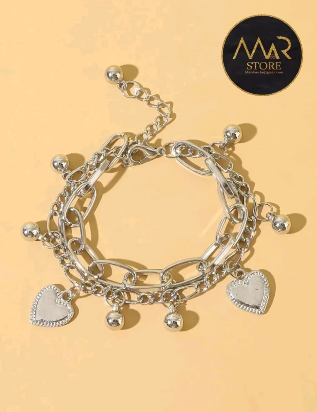 Pulsera con dijes ajustable en acero inoxidable color plata 